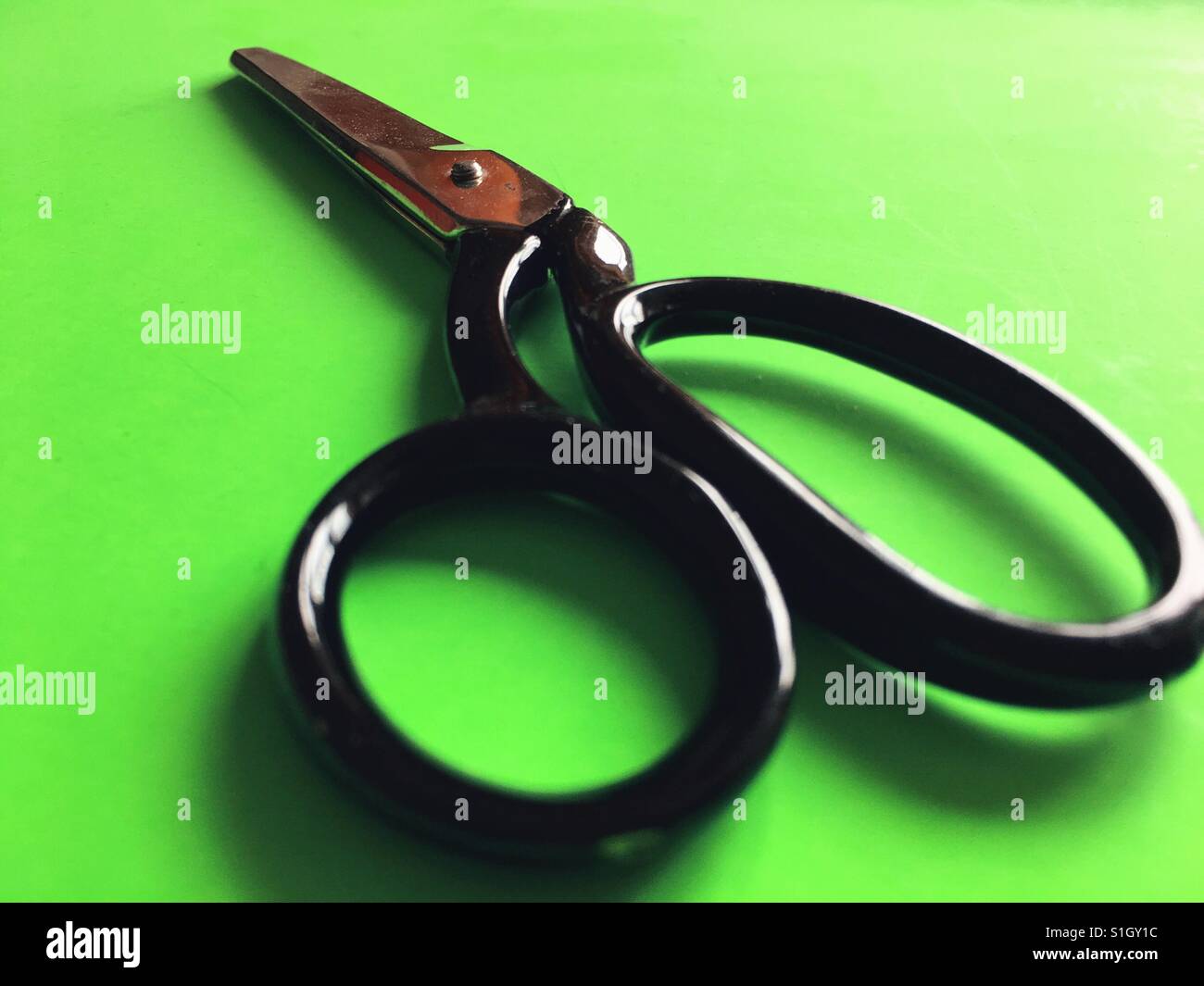 Vintage scissors on green background - Smartphone Captured Stock Image