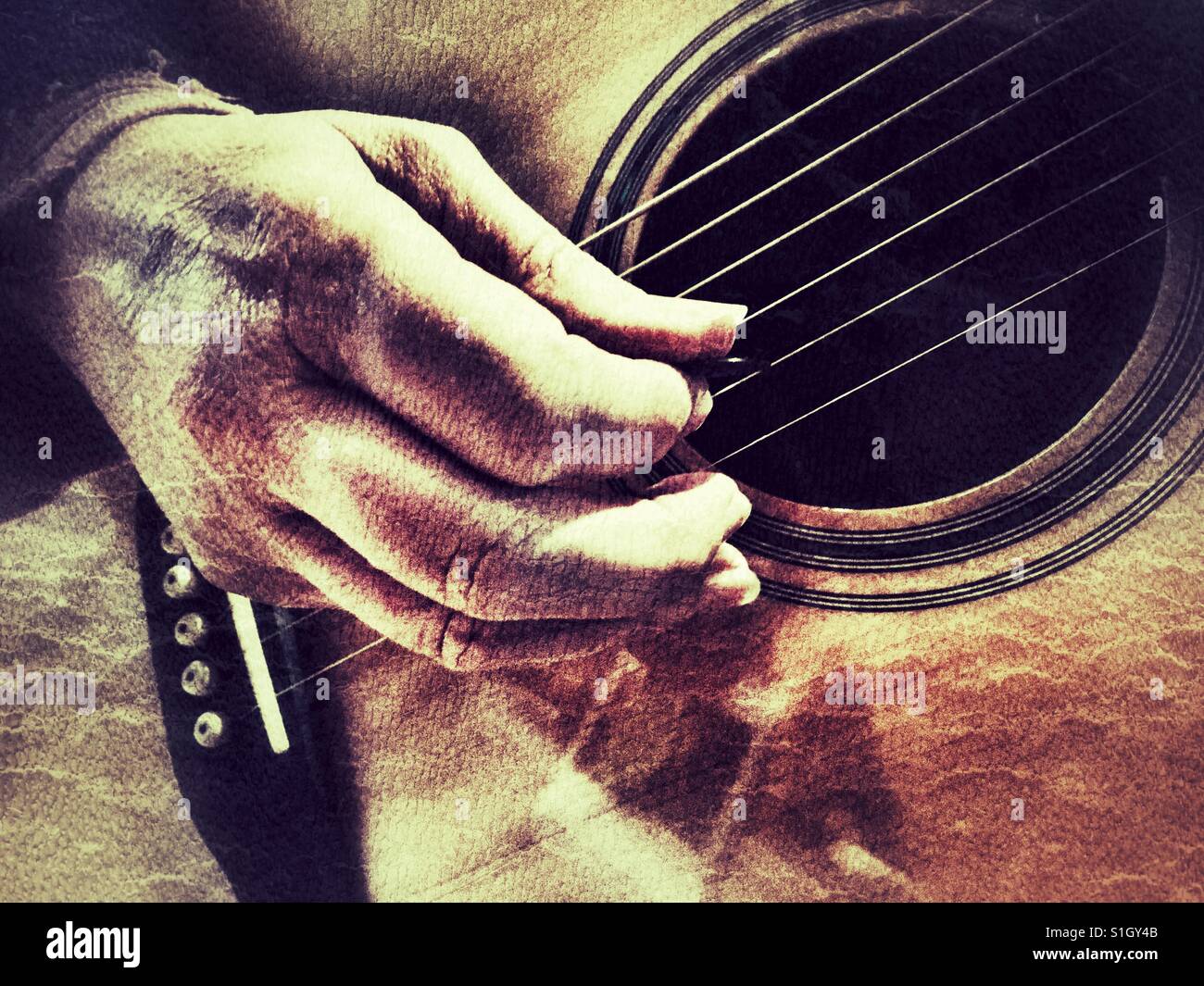 Woman playing steel string acoustic guitar with a pick - Smartphone Captured Stock Image
