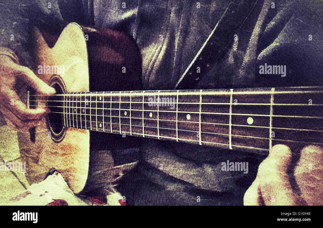 Woman playing a steel string acoustic guitar - Smartphone Captured Stock Image