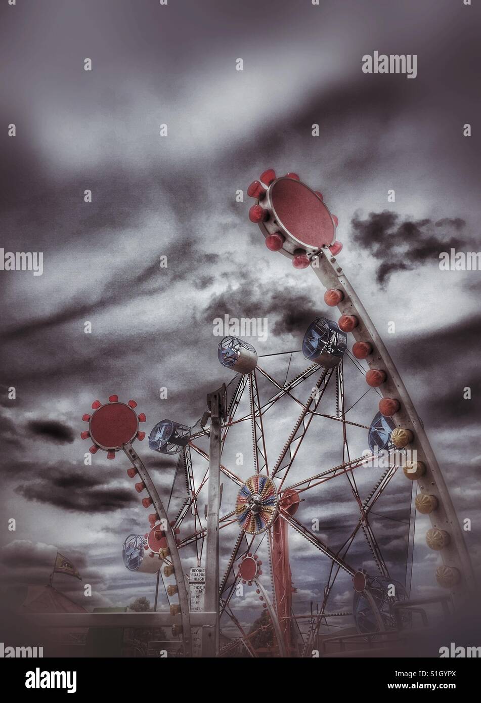 Carnival rides against dramatic sky - Smartphone Captured Stock Image