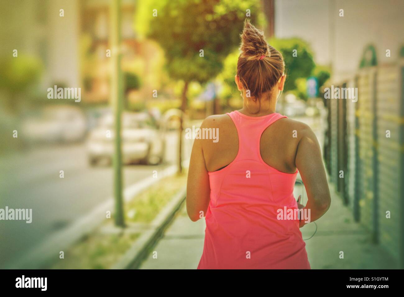Woman running  during a hot morning - Smartphone Captured Stock Image
