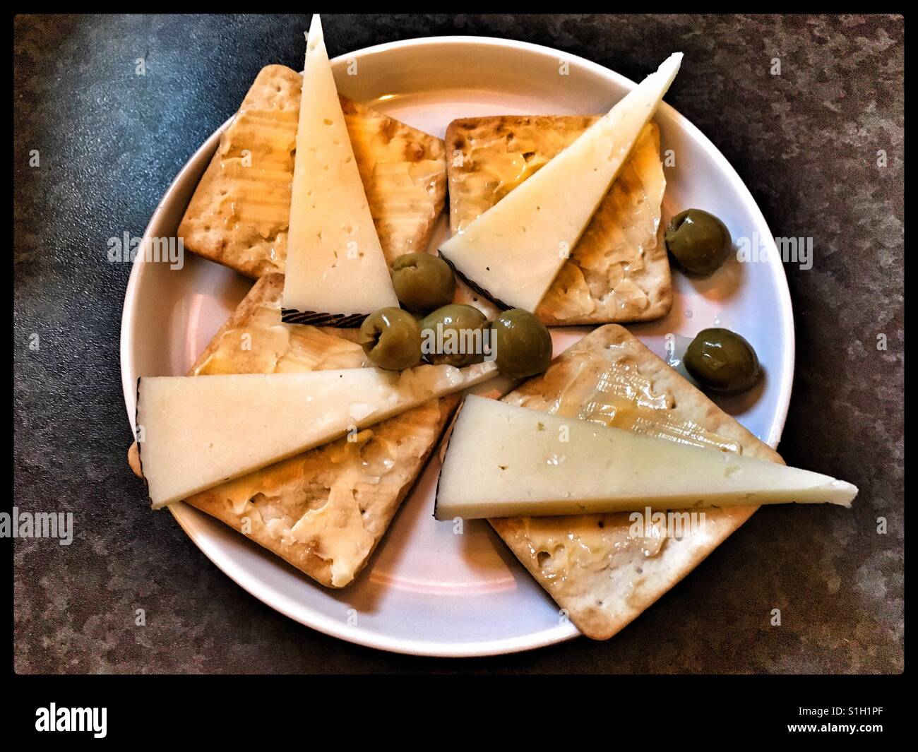 Tapas of Manchego Cheese, olives and cream crackers Stock Photo Alamy