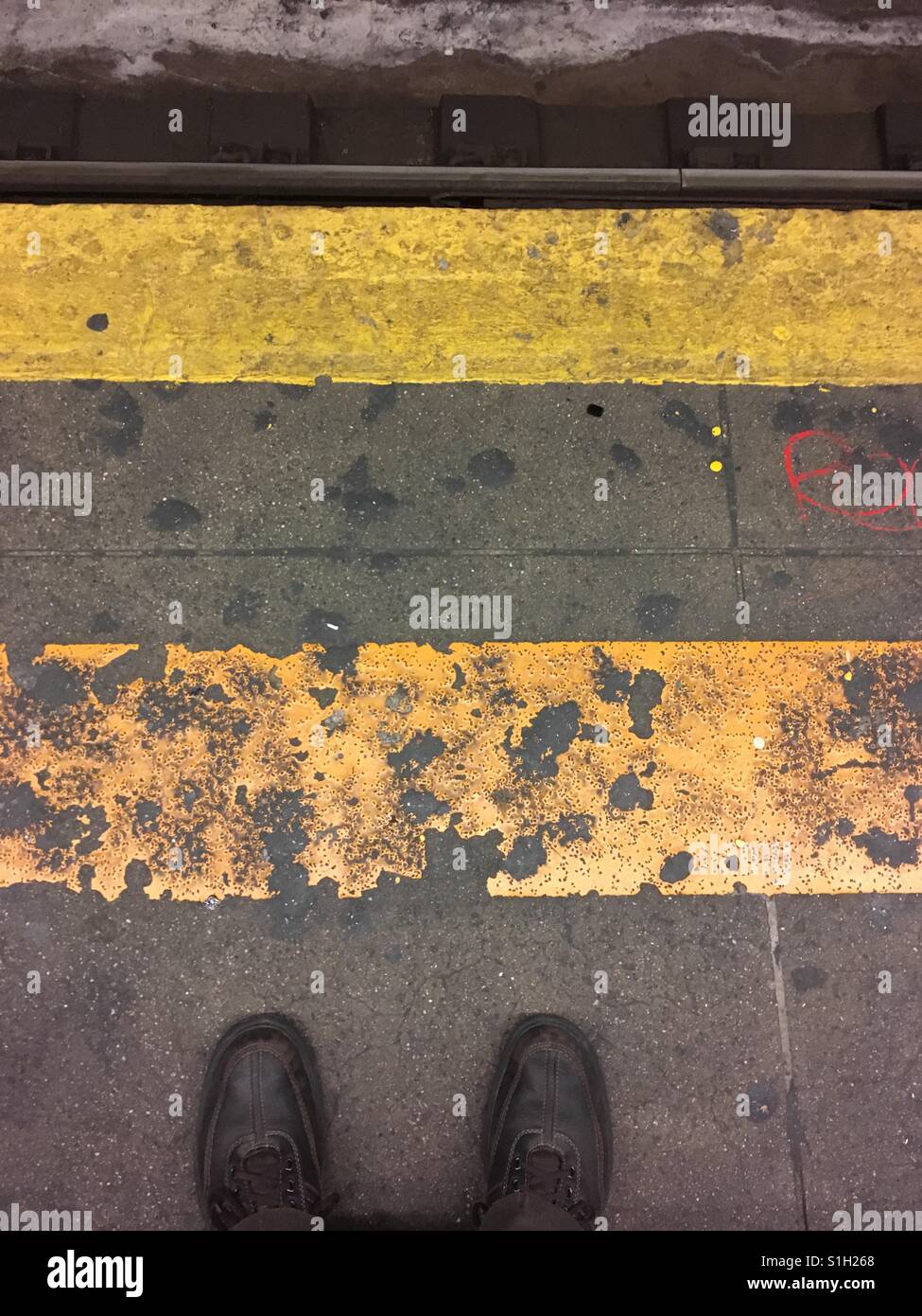 Waiting on a New York City subway platform for a train at midnight. - Smartphone Captured Stock Image