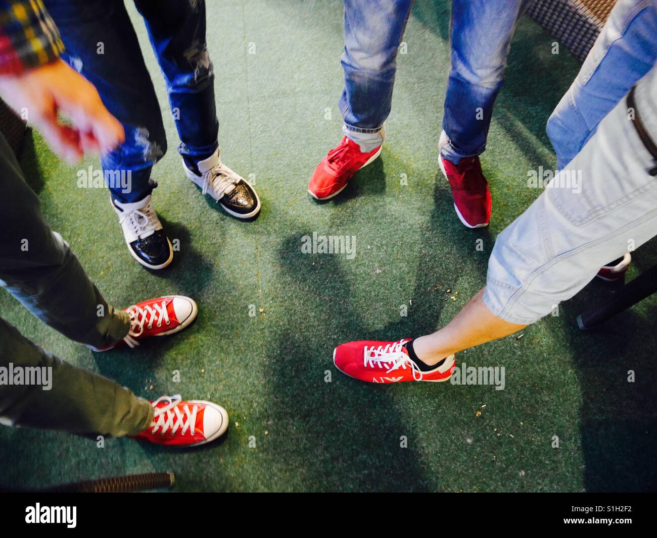 Millenials outside bar in Finland get together view of feet teamwork - Smartphone Captured Stock Image