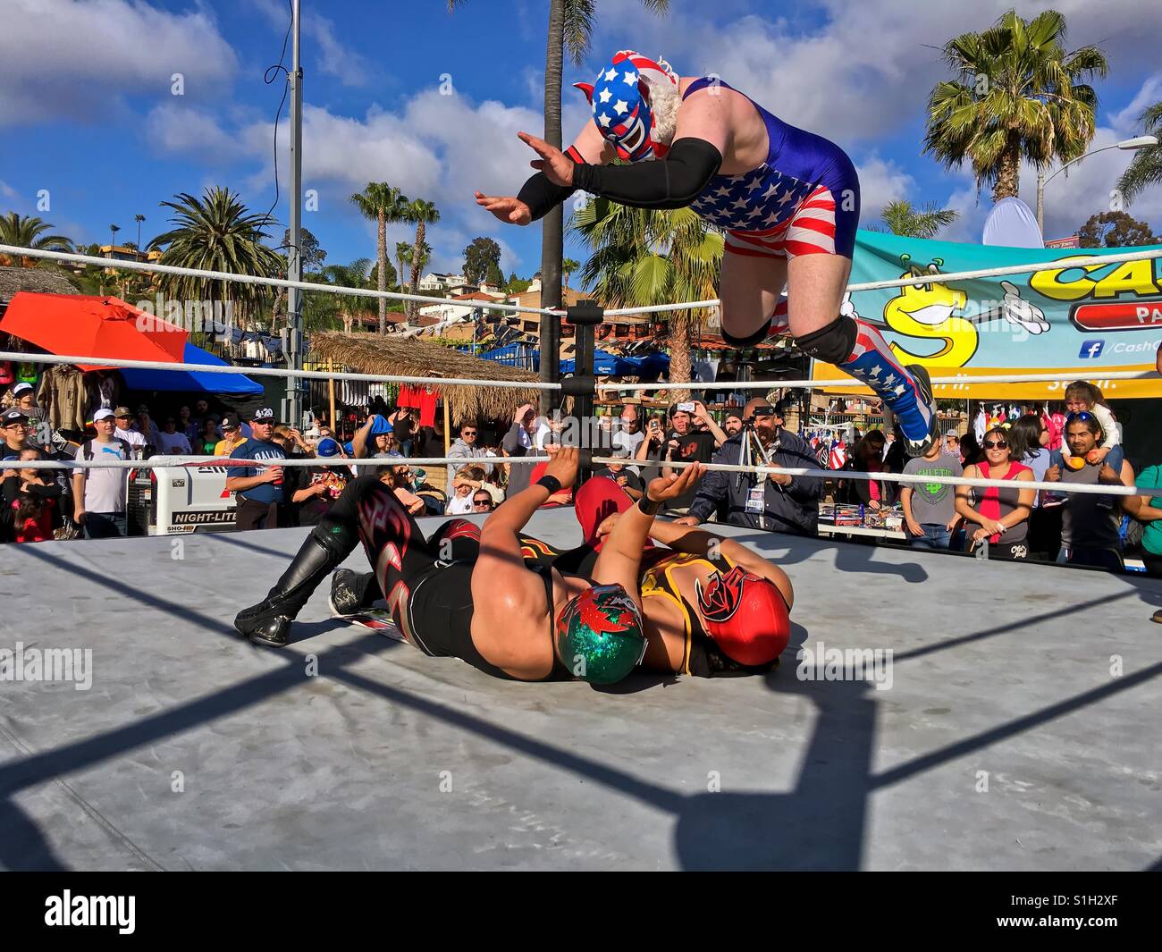 Lucha Libre Mexican Wrestling match with wrestler performing a body drop. Lucha Libre is Spanish for free fight and is a term used in Mexico for a form of professional wrestling. Taken 6 May 2016. Stock Photo