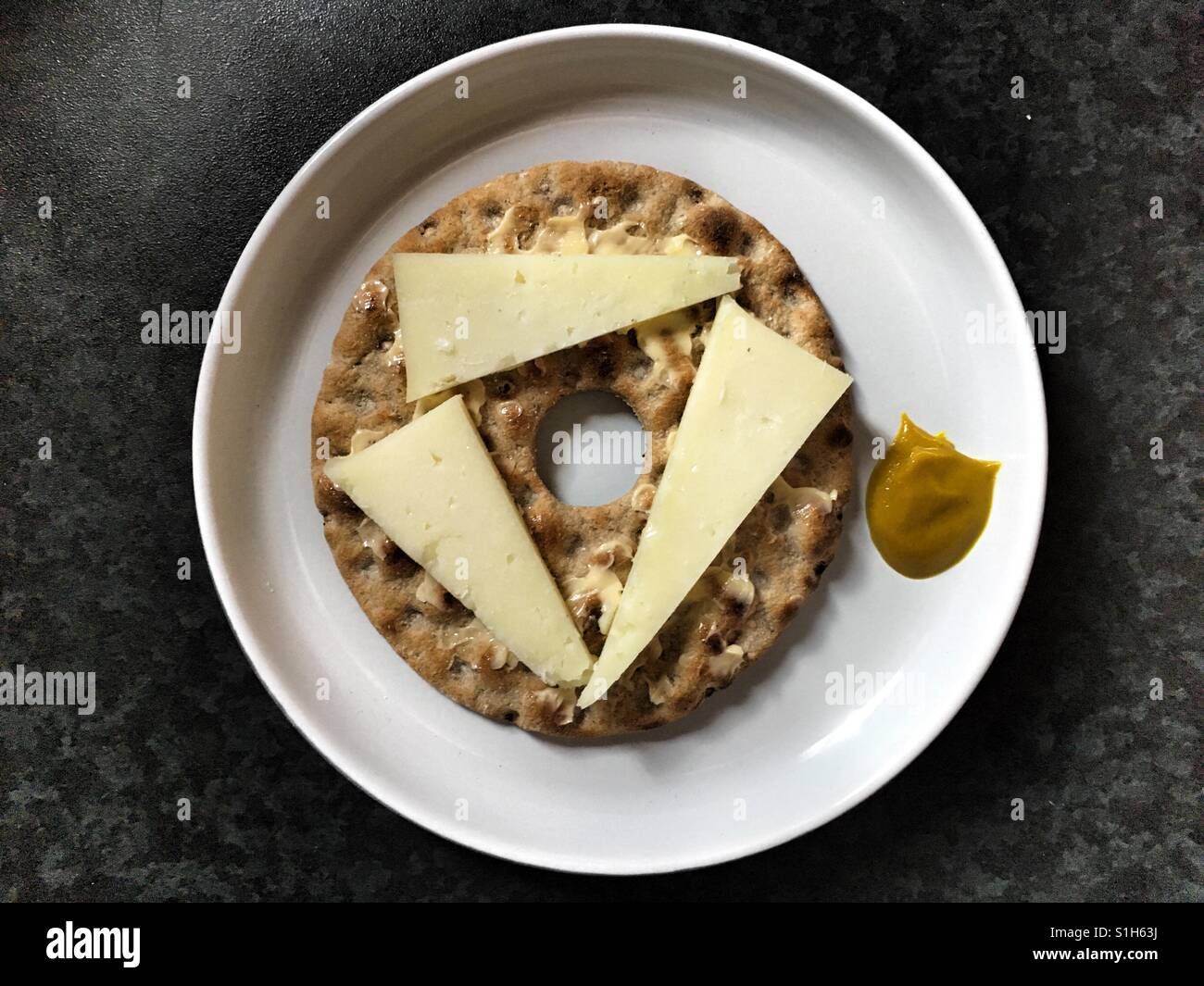 Pyramid Spelt-Dinkel Brod with Manchego cheese and English Mustard. Stock Photo