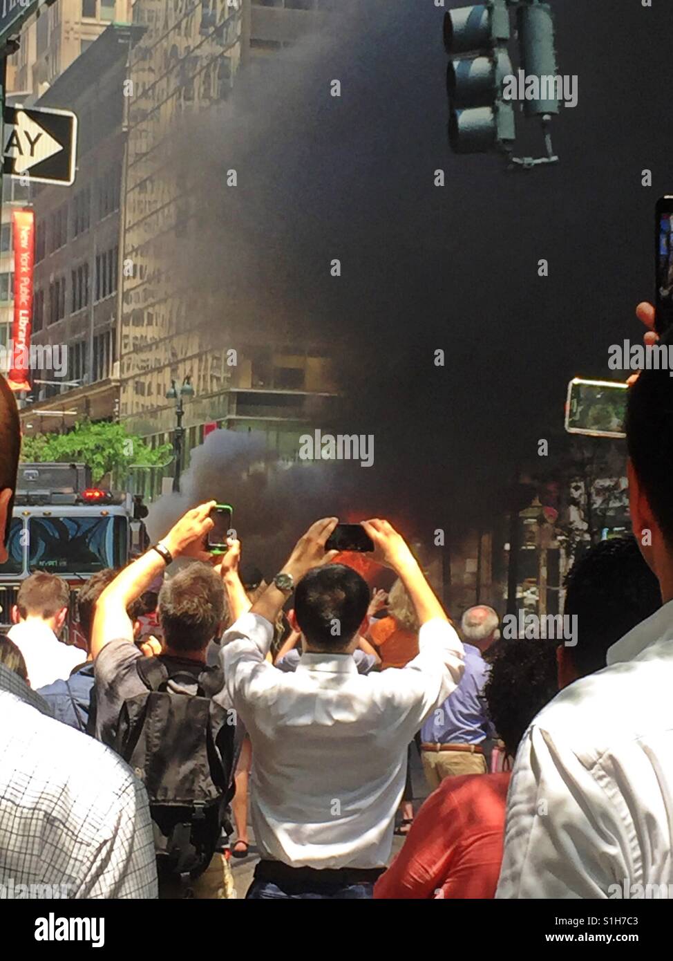 Spectators taking photographs of burning automobile on fifth Ave., Manhattan, NYC, USA - Smartphone Captured Stock Image