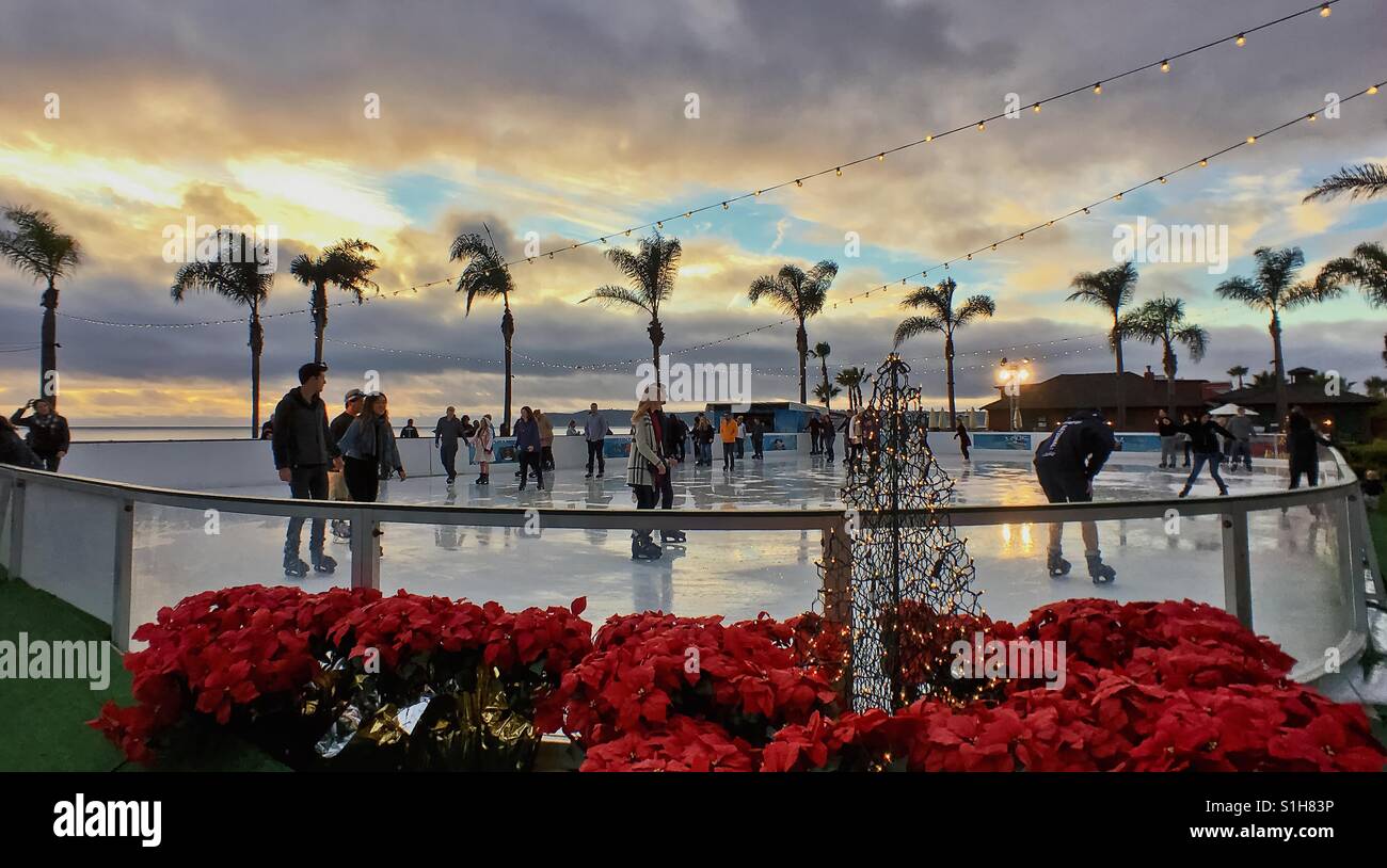 Coronado, California, USA - December 9, 2016: People skating at an outdoor ice rink on the lawn of the Hotel Del Coronado during Christmas festivities. Concept of Christmas festivities, winter, fun Stock Photo
