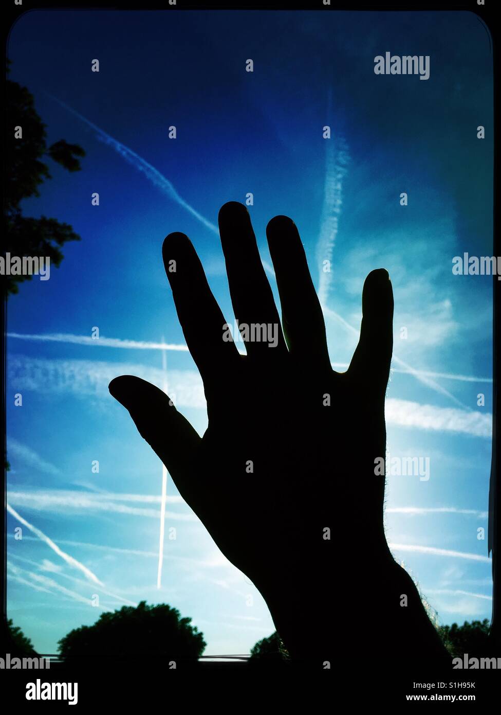 Silhouette of a hand against blue sky Stock Photo - Alamy