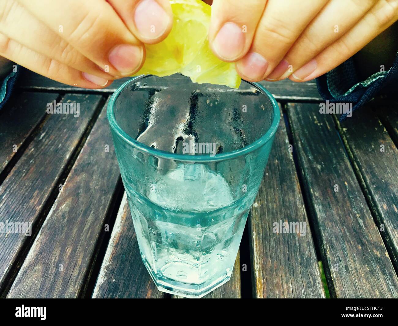 Squeezing lemon in an elderflower drink - Smartphone Captured Stock Image