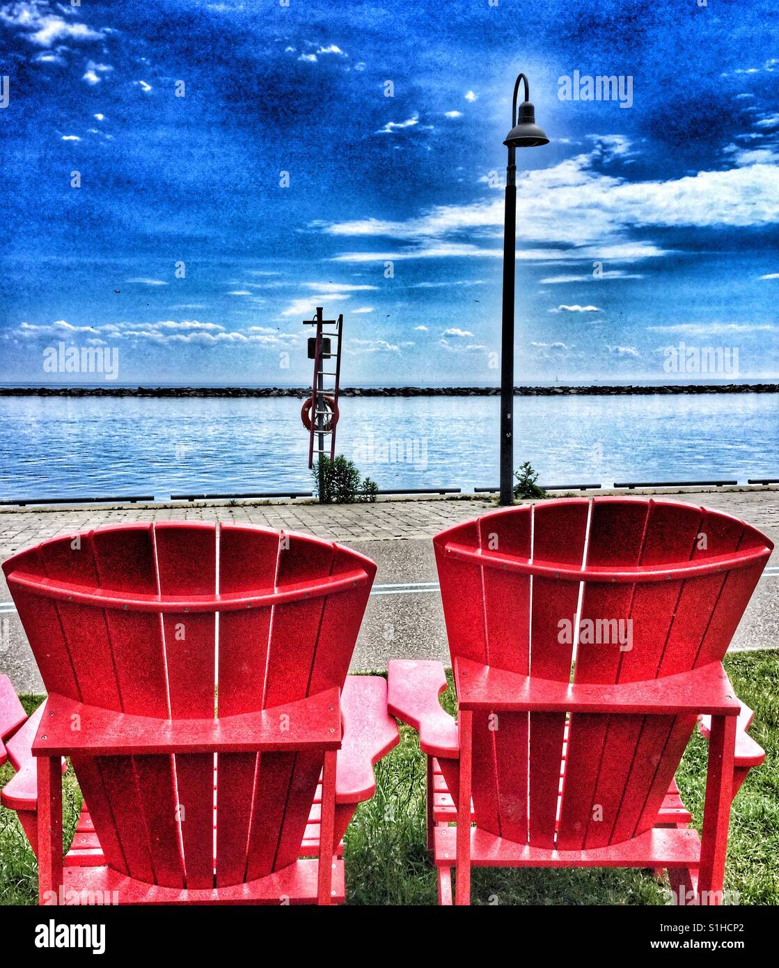 Two red Muskoka chairs on Toronto’s waterfront Stock Photo Alamy