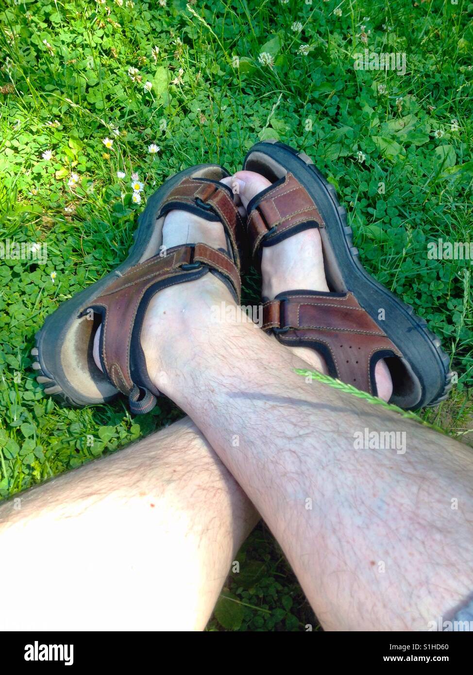 Male feet wearing sandals Stock Photo - Alamy