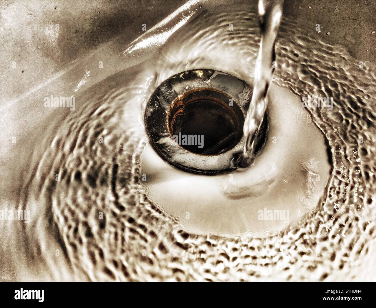 Water running down the plug hole Stock Photo