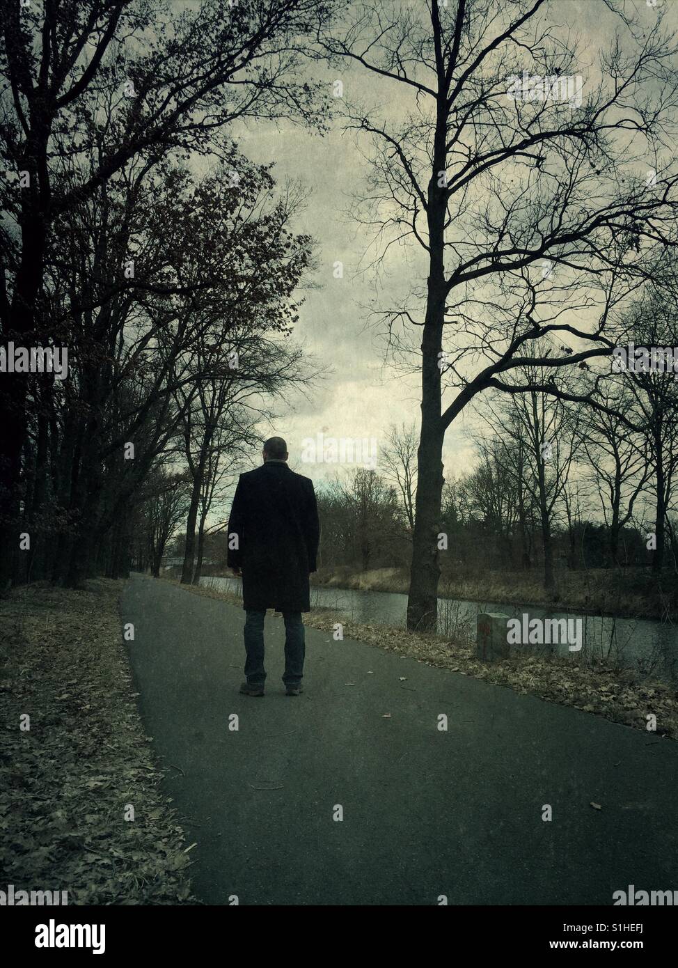 Man wearing a coat standing by the lake - Smartphone Captured Stock Image