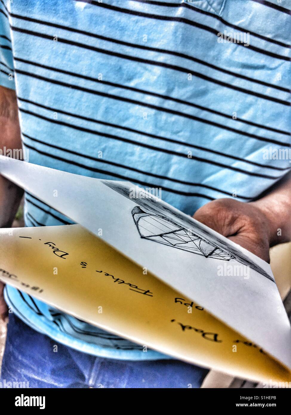 Father's Day, Dad looking at his handmade homemade card. - Smartphone Captured Stock Image