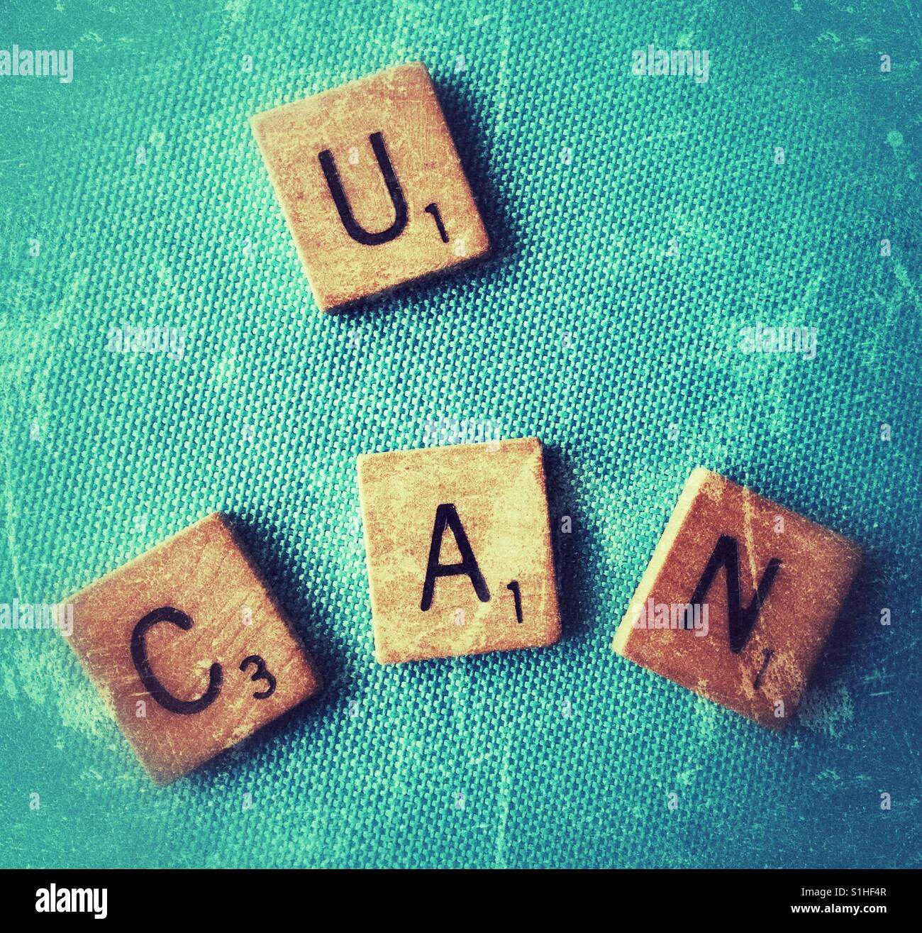 Scrabble letters spelling U Can. - Smartphone Captured Stock Image