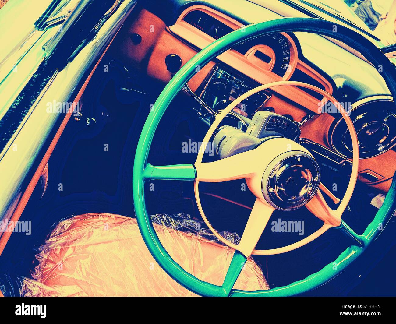 Classic car steering wheel and plastic covered seat - Smartphone Captured Stock Image