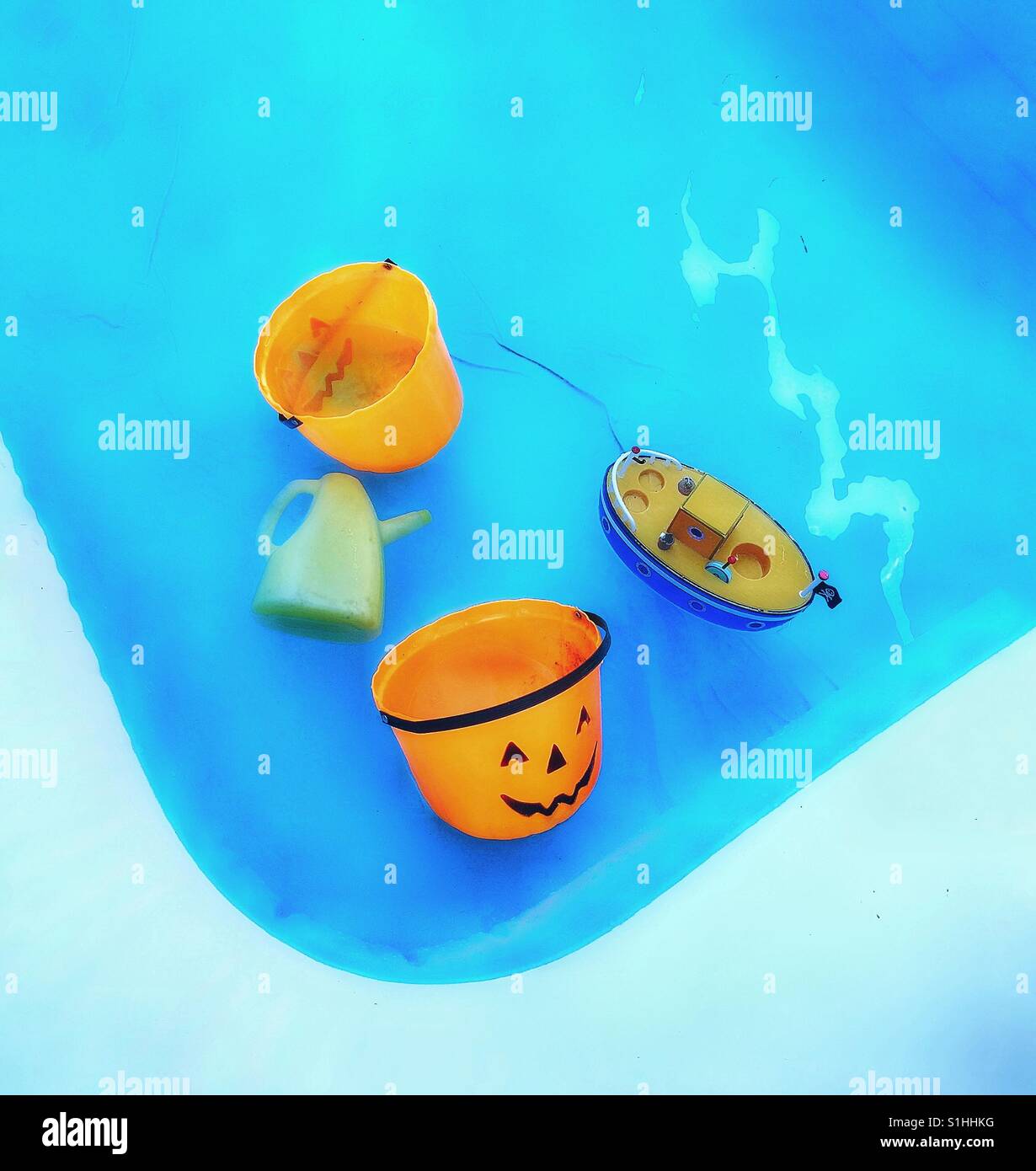 Kids toys floating in a paddling pool. - Smartphone Captured Stock Image