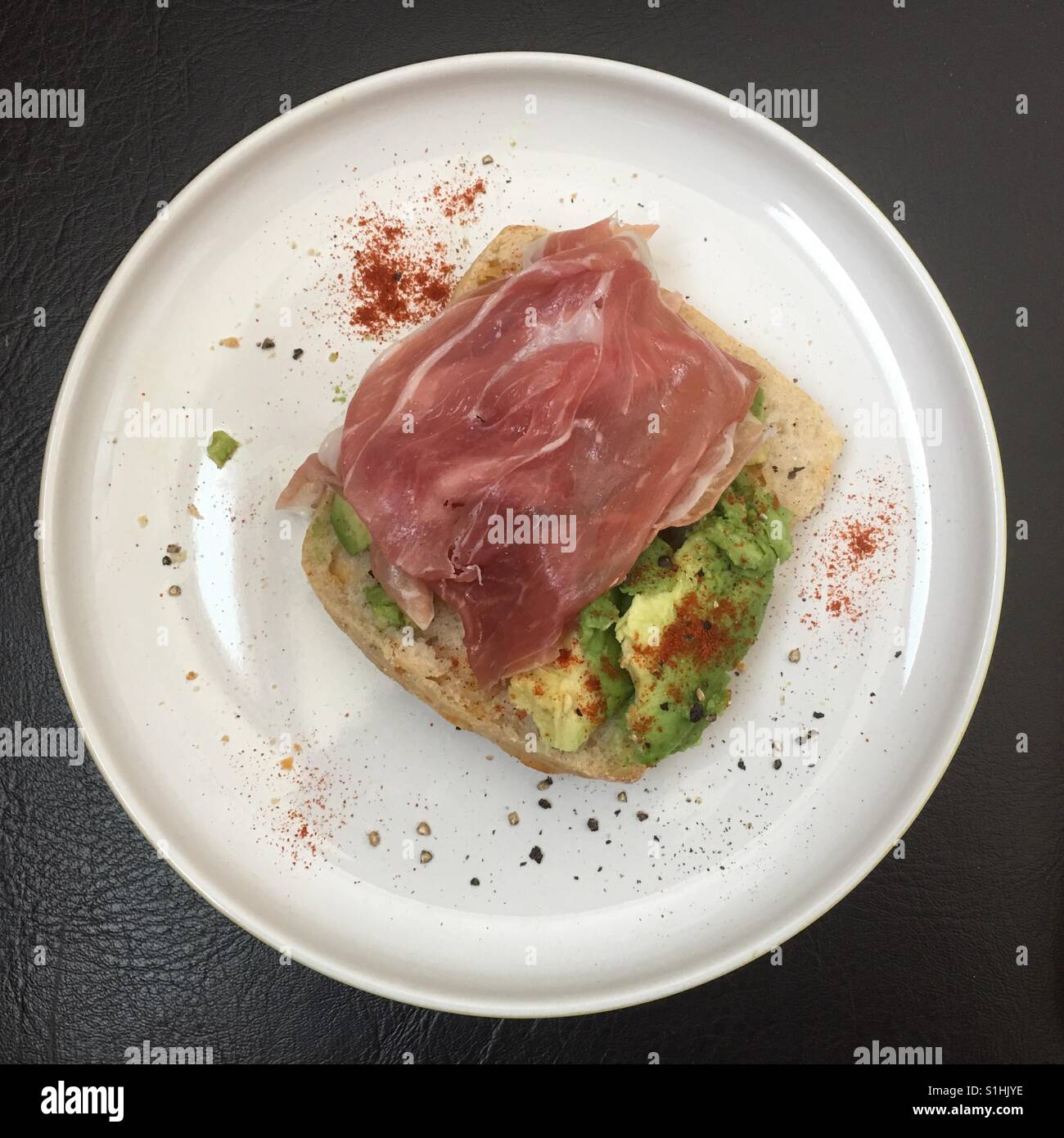 Parma ham and crashed avocado on bread - Smartphone Captured Stock Image