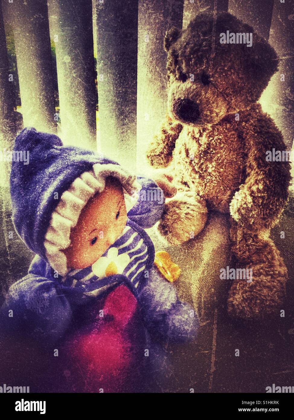 Friends, a baby doll and stuffed teddy bear. Stock Photo