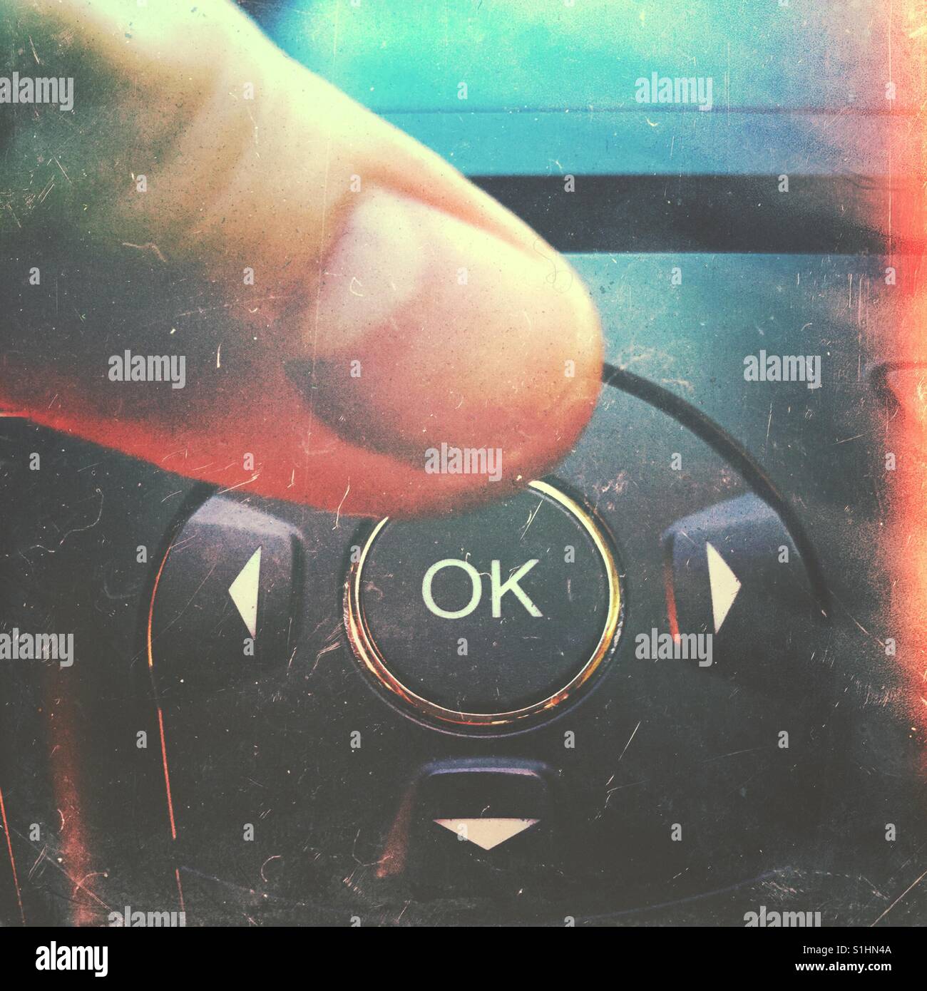 Finger pressing OK button - Smartphone Captured Stock Image