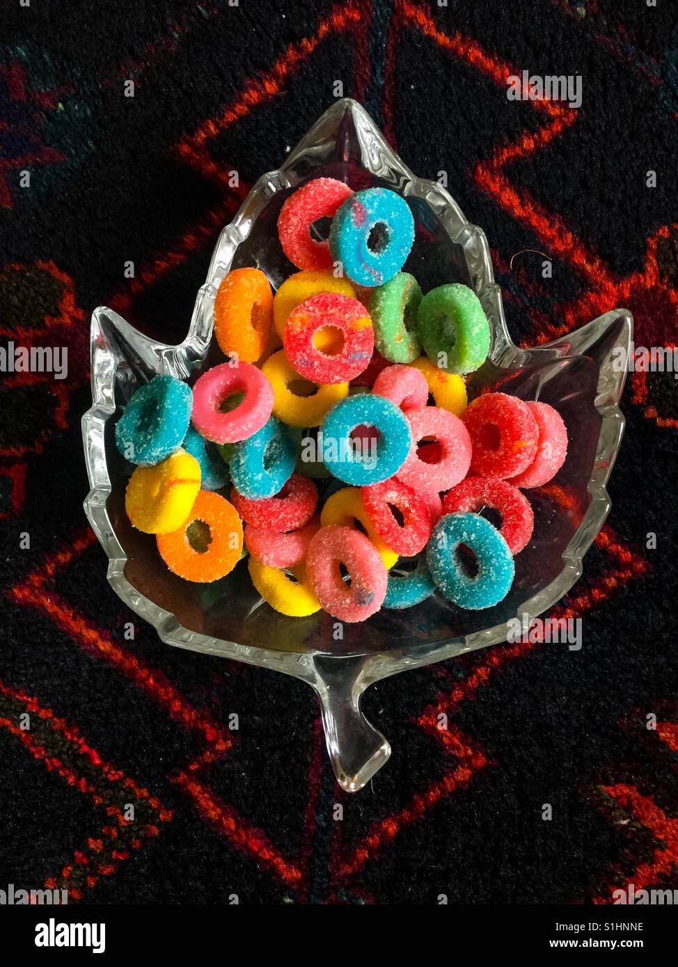 Canadian motif: Maple Leaf shaped dish with candy of many colours, symbolic of the Canadian flag and Canada’s multicultural, multiethnic, mosaic society - Smartphone Captured Stock Image