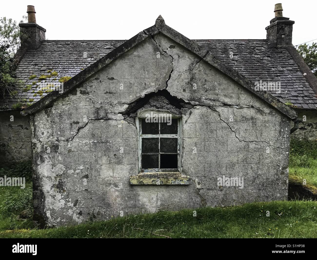 Cracks in the brickwork around the window of an remote old house on the Isle of Mull, Scotland. Stock Photo