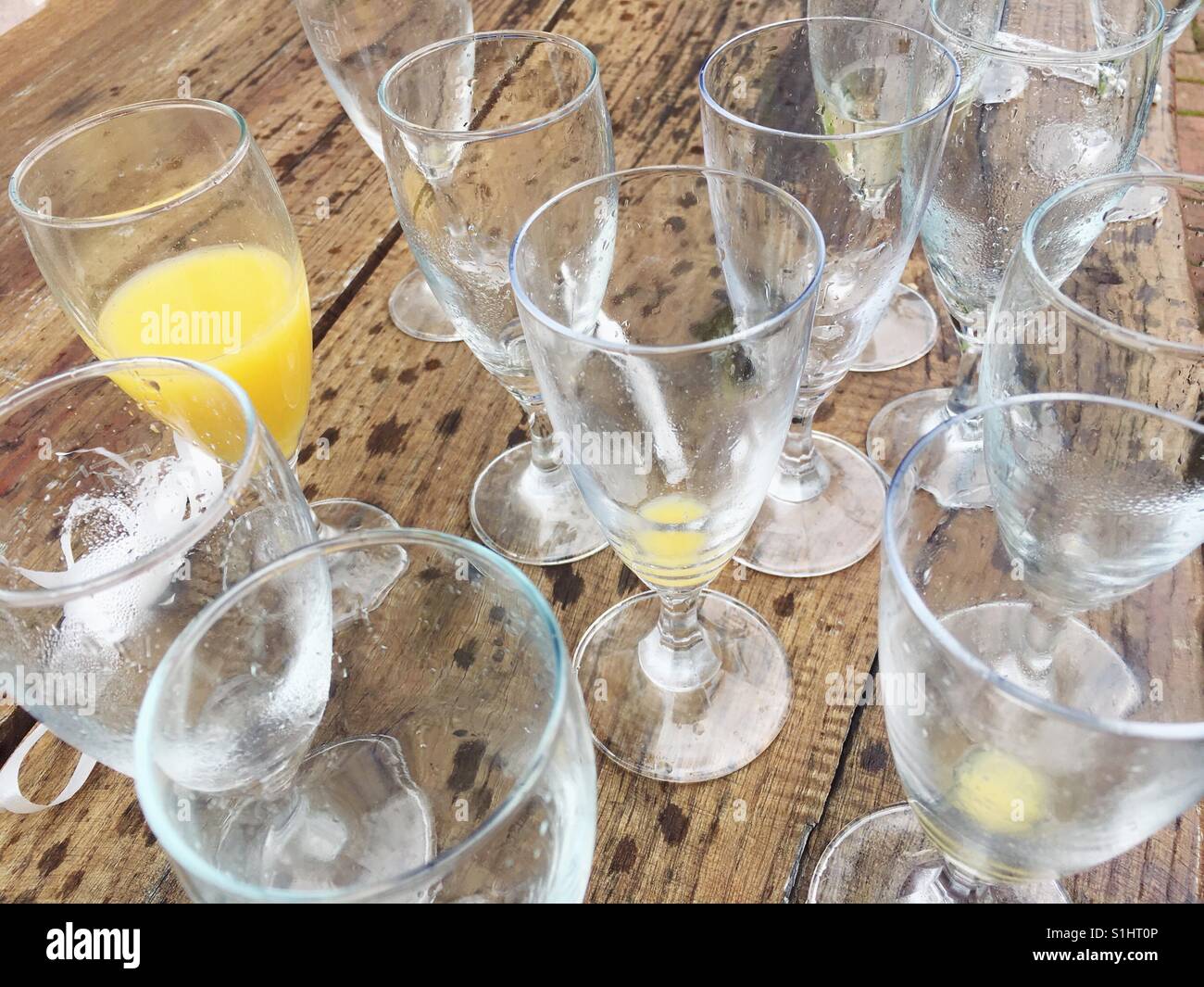 Empty champagne glasses on a wooden table - Smartphone Captured Stock Image