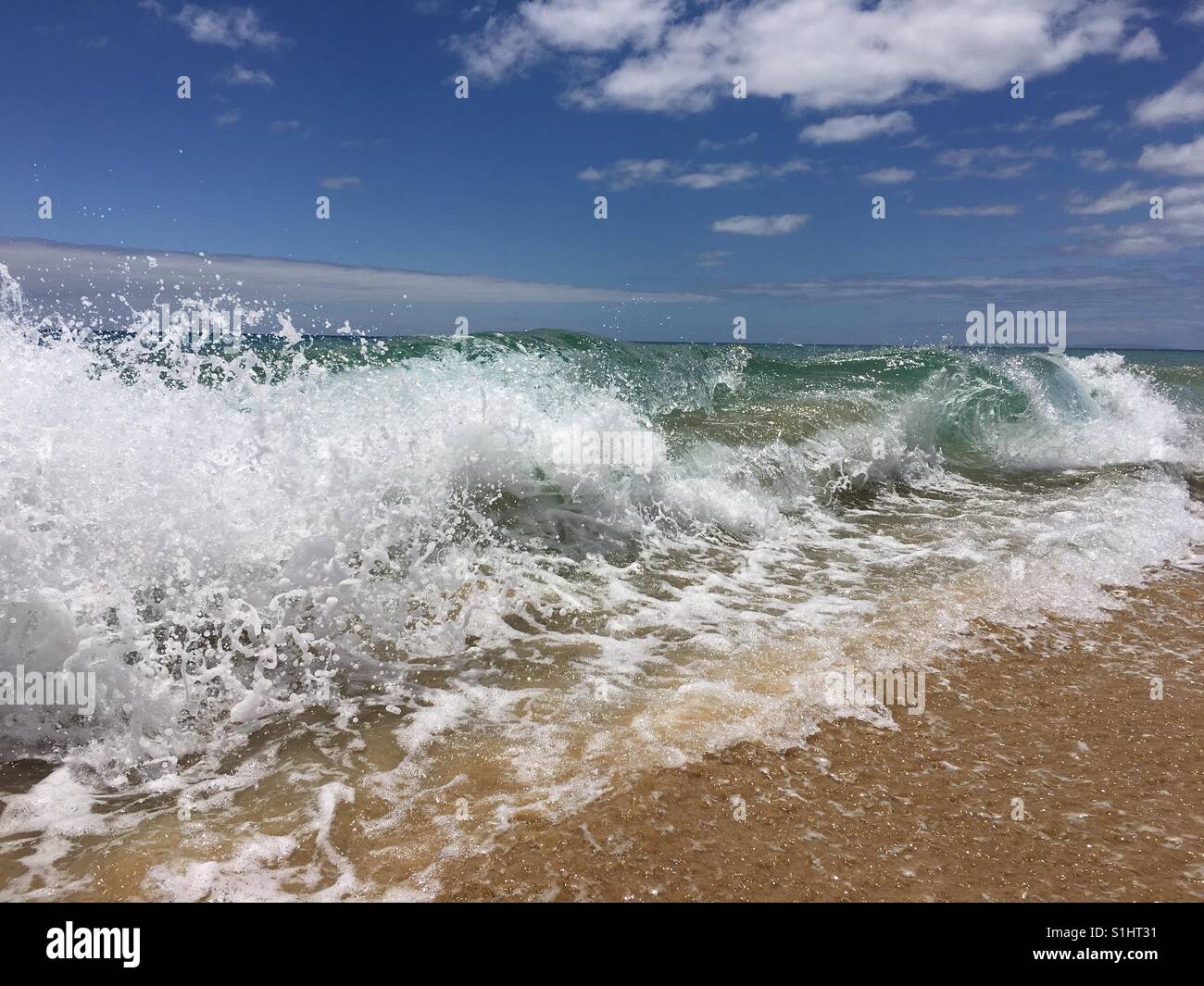 Waves crashing on a sandy beach - Smartphone Captured Stock Image