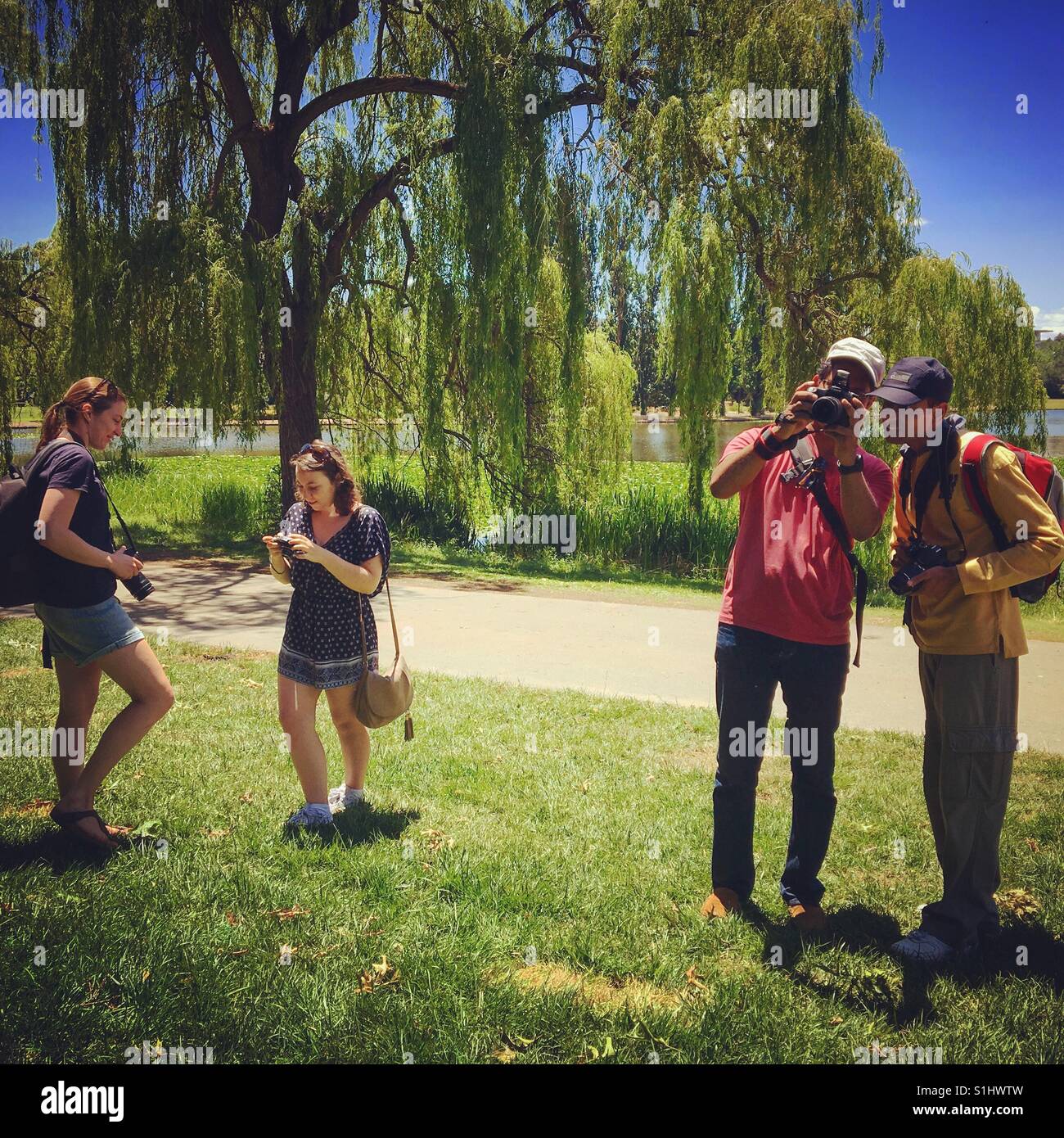 People taking photos on a photography course - Smartphone Captured Stock Image