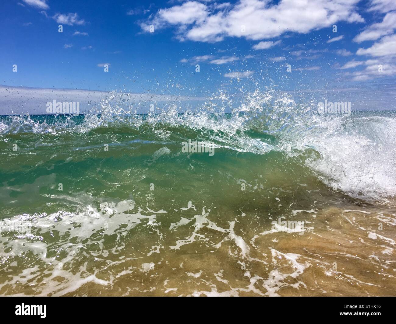 Waves crashing on a sandy beach - Smartphone Captured Stock Image