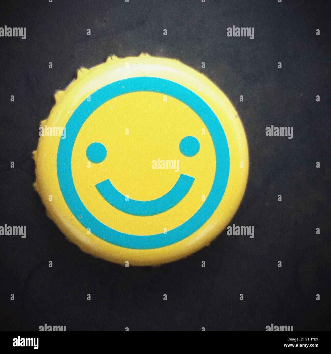 Happy smiley face emoji bottle top. Stock Photo