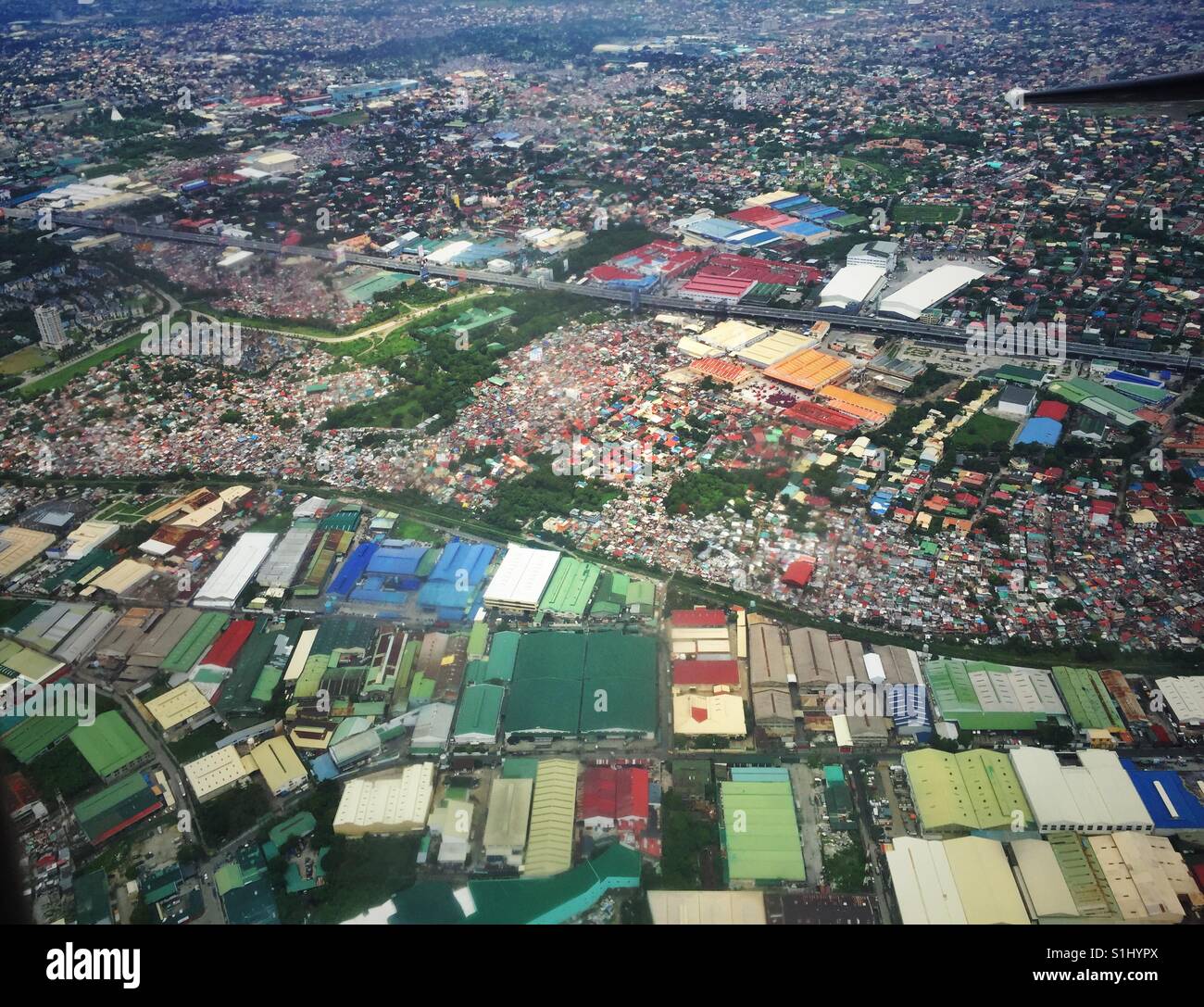 Densely packed slums in Manila Philippines as seen from the plane - Smartphone Captured Stock Image