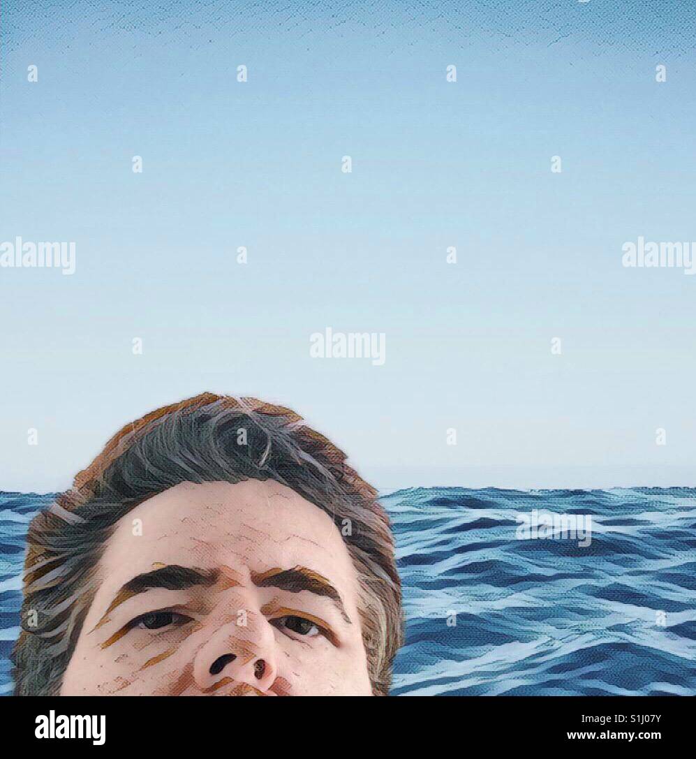Man in the sea looking at the camera from above - Smartphone Captured Stock Image