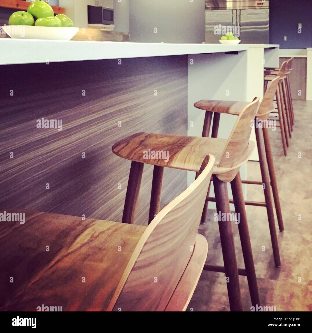 Office space cafeteria renovation featuring bar stools at a cafe counter. Stock Photo
