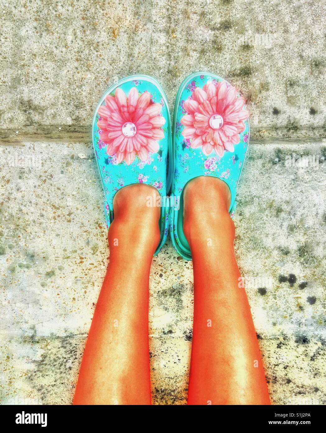 A child's colourful shoes with a flower motif. - Smartphone Captured Stock Image