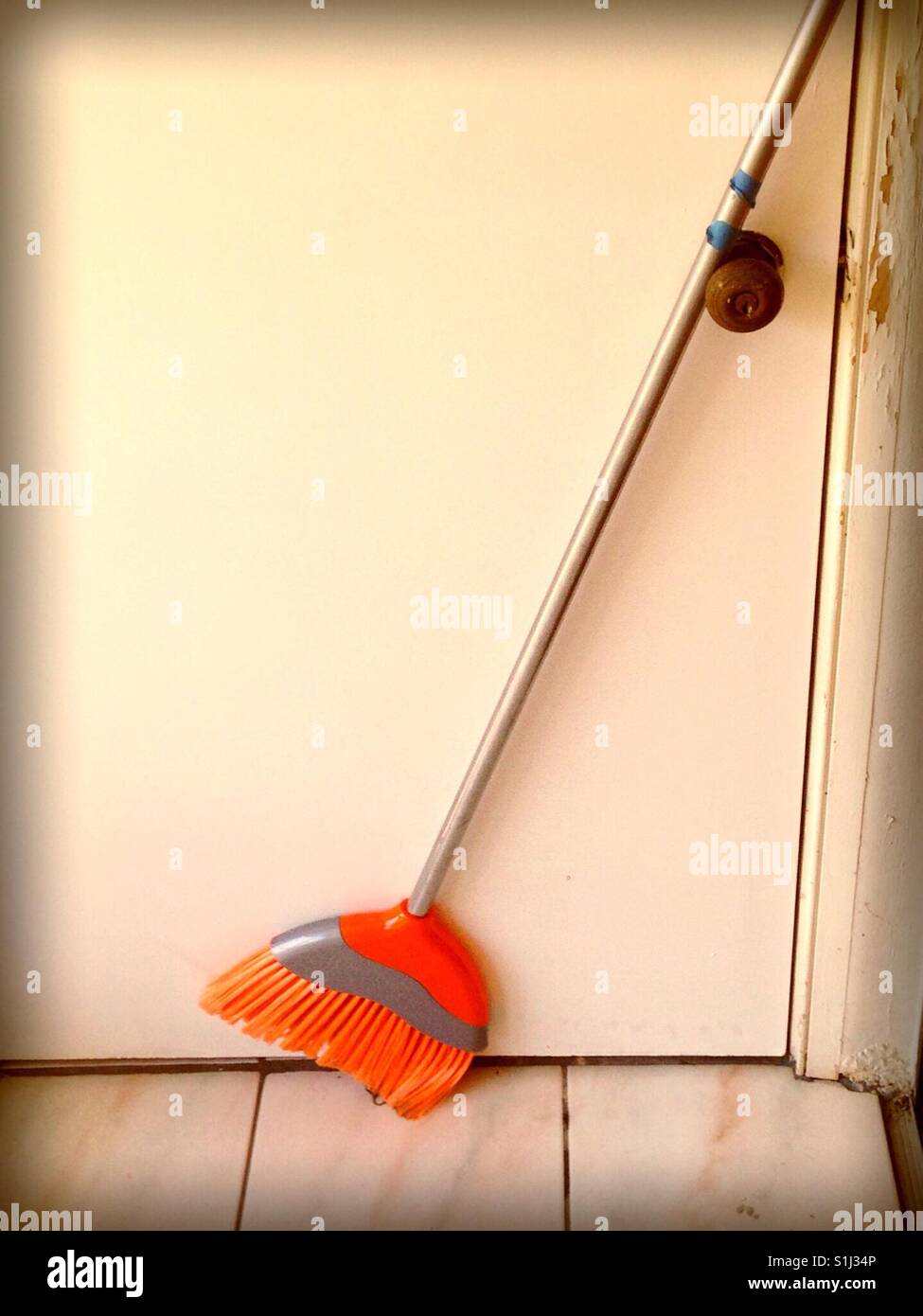 close up broom by door Stock Photo Alamy