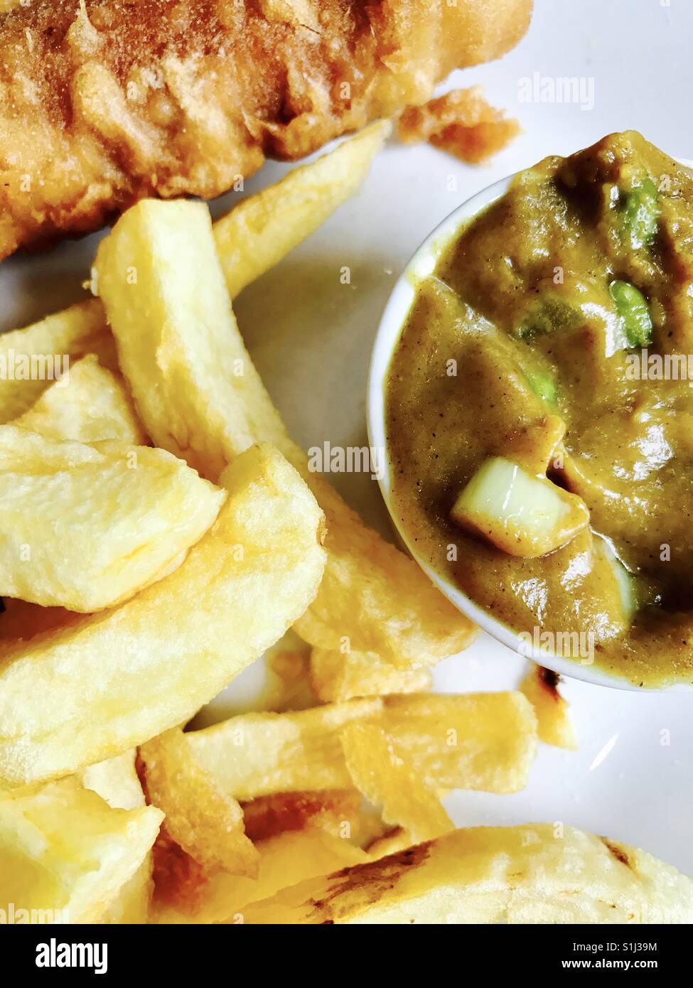 Fish, chips and curry sauce Stock Photo Alamy