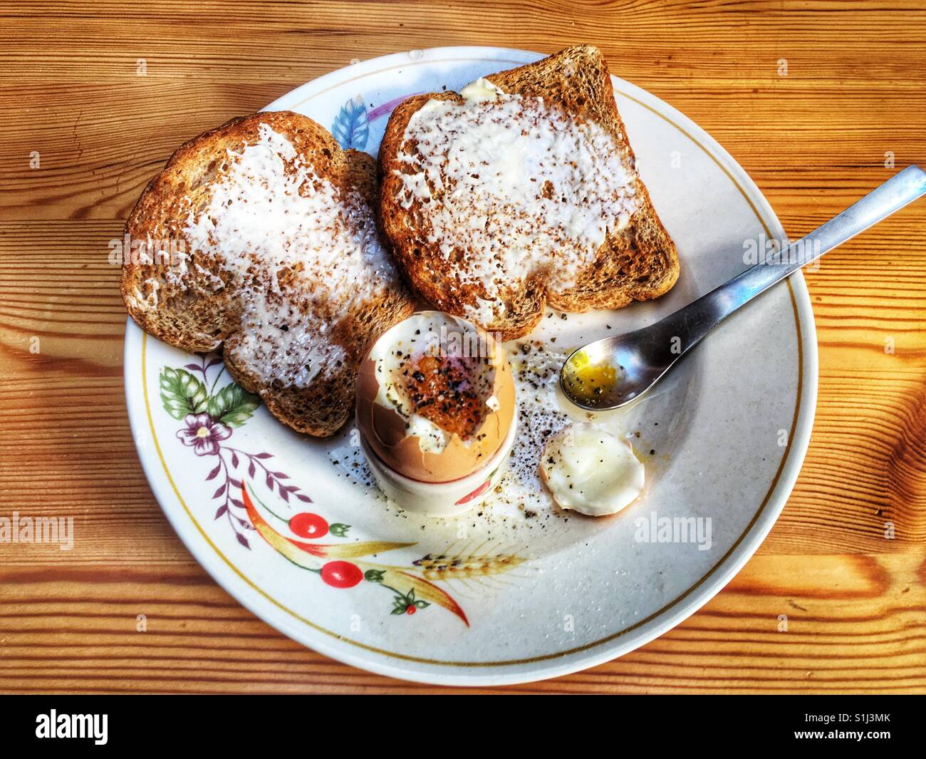 Boiled egg with wholemeal toast and cracked black pepper and salt - Smartphone Captured Stock Image