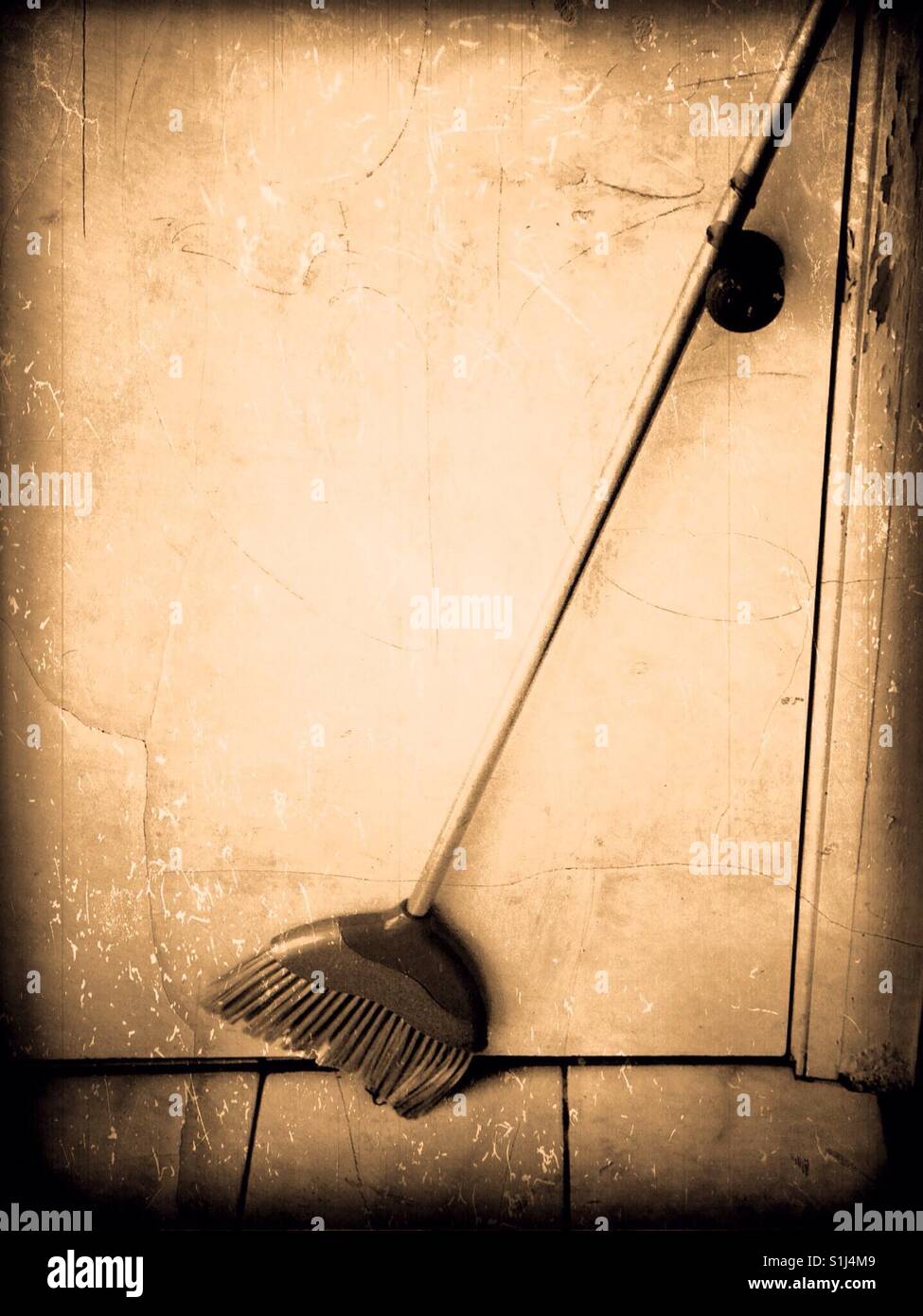 close up broom by door Stock Photo Alamy