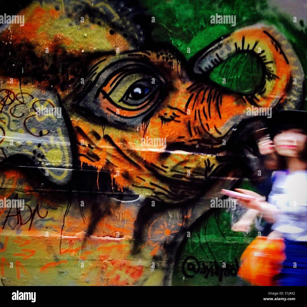 Street art with blurred girl with handbag - Smartphone Captured Stock Image