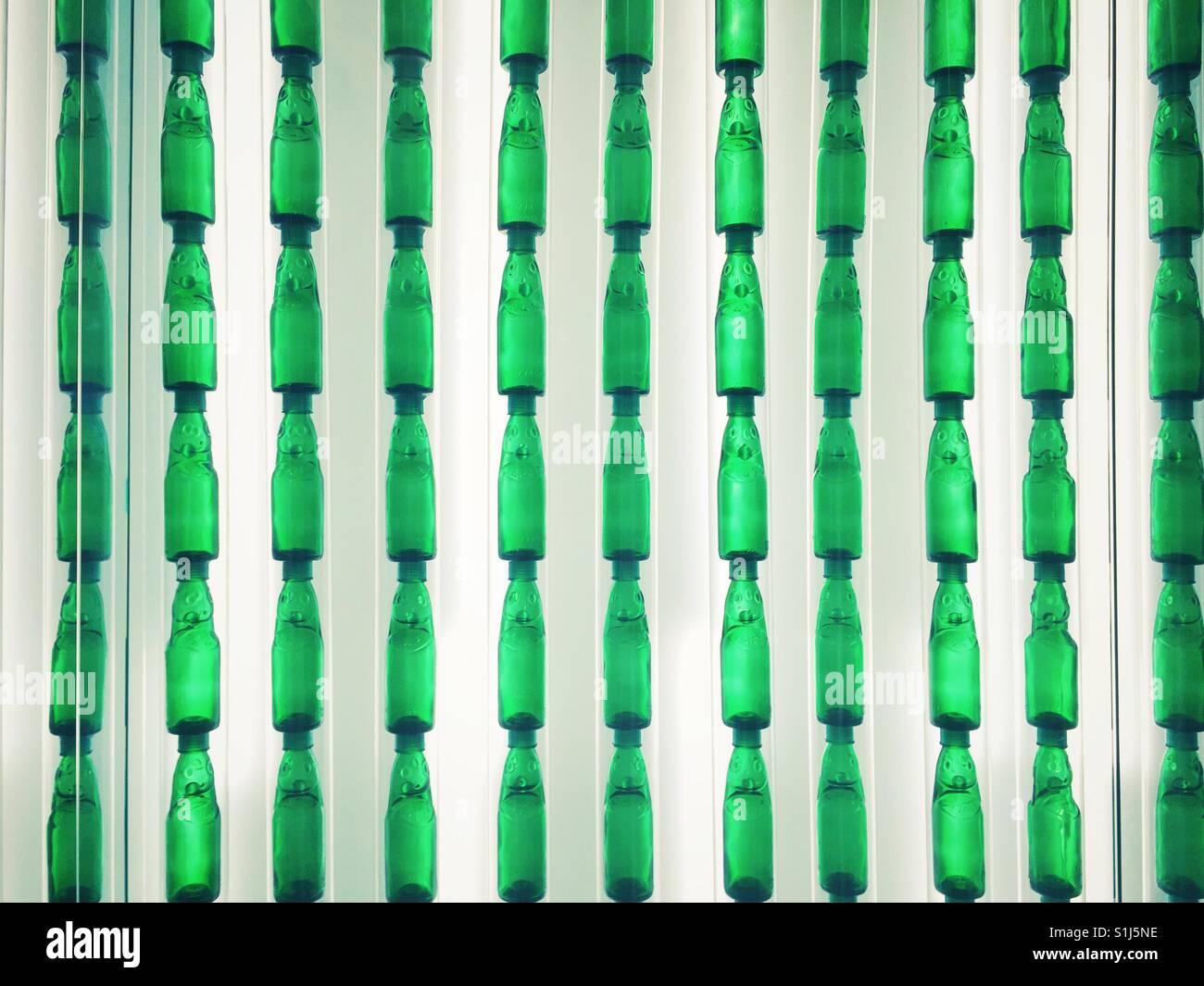 Wall of green bottles in Taipei International Airport terminal - Smartphone Captured Stock Image