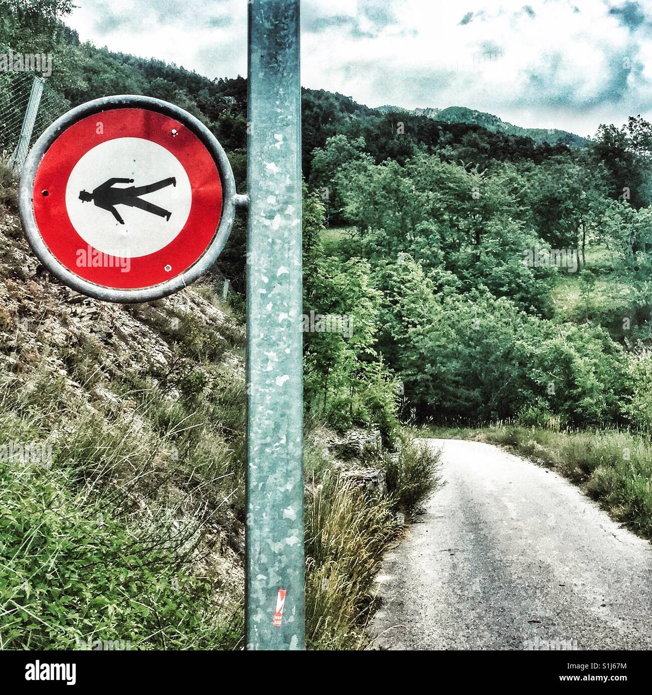 Sideways no pedestrians sign on a country road, Switzerland Stock Photo