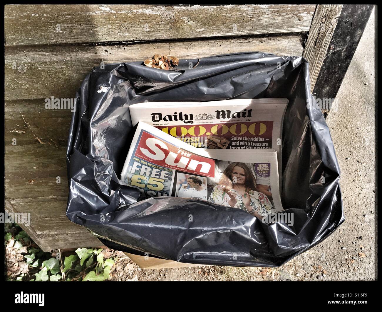 Gutter Press discarded into a bin Stock Photo Alamy