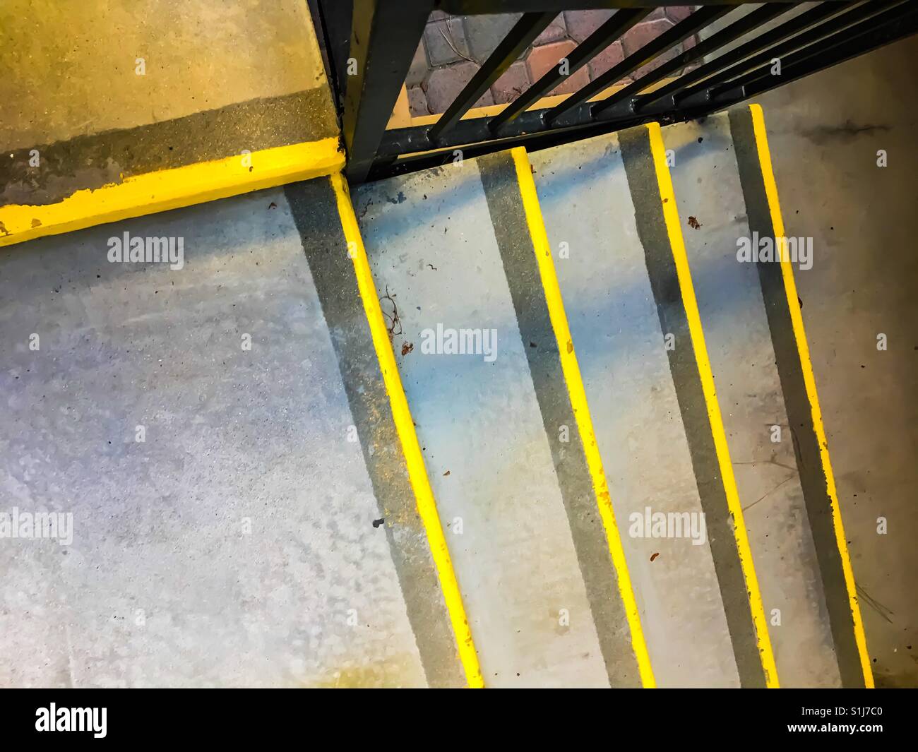 Stairway with yellow safety strips as if floating lines on steps Stock Photo