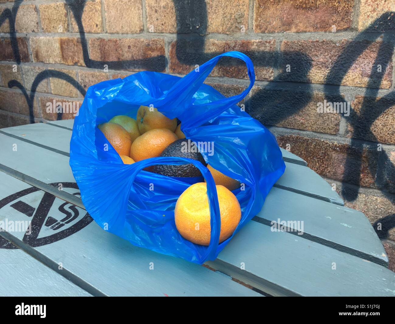 Brick lane shopping bag full of fruit on a table of Electric cinema cafe with graffiti - Smartphone Captured Stock Image