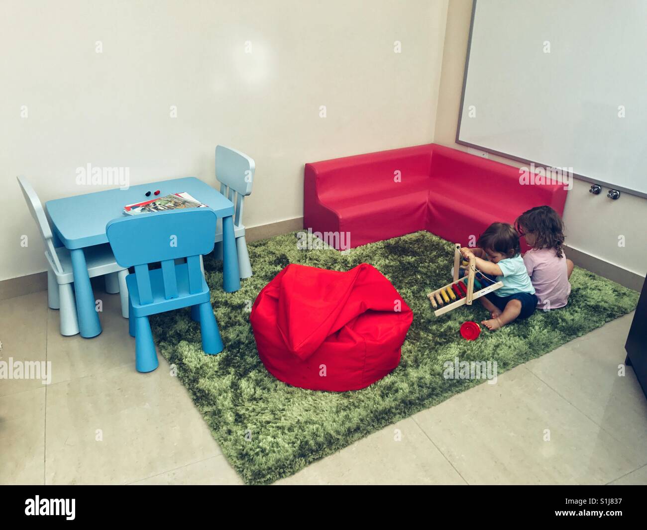 Siblings playing togheter at home - Smartphone Captured Stock Image
