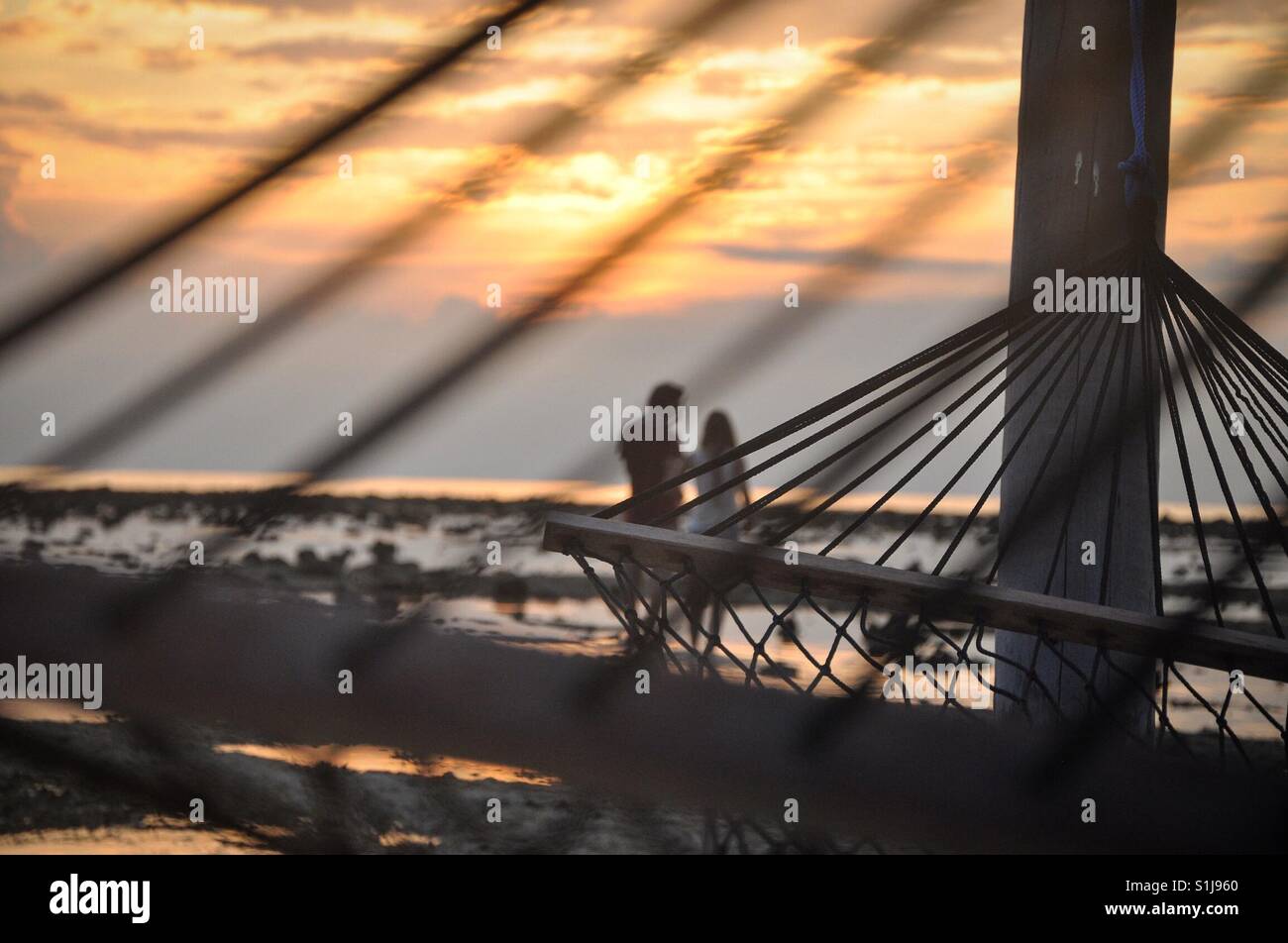 Couple enjoying their time together while watching the sun sets Stock Photo