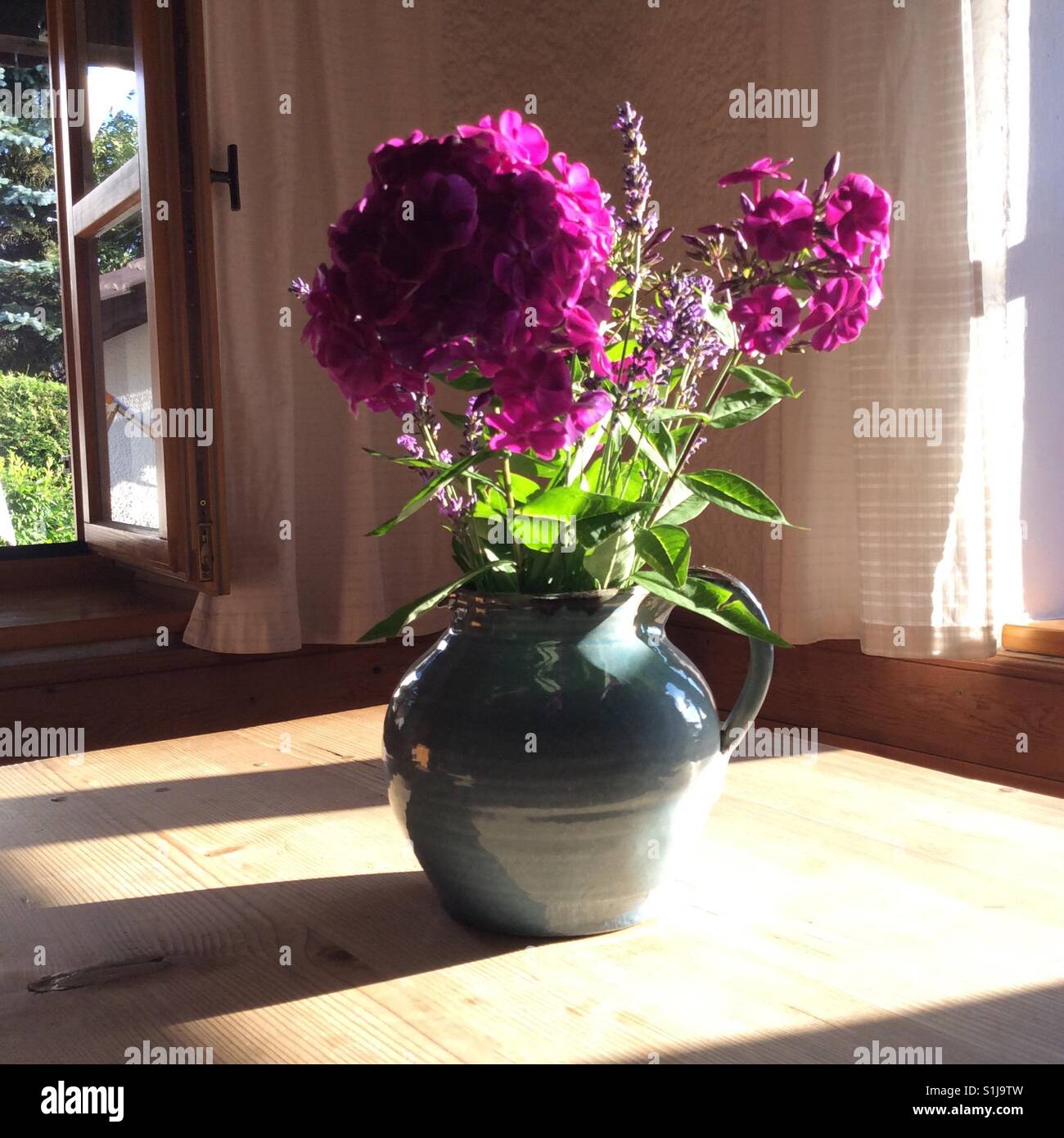 Flower bouquet such as phlox and lavender on vintage wooden table in farmhouse Stock Photo