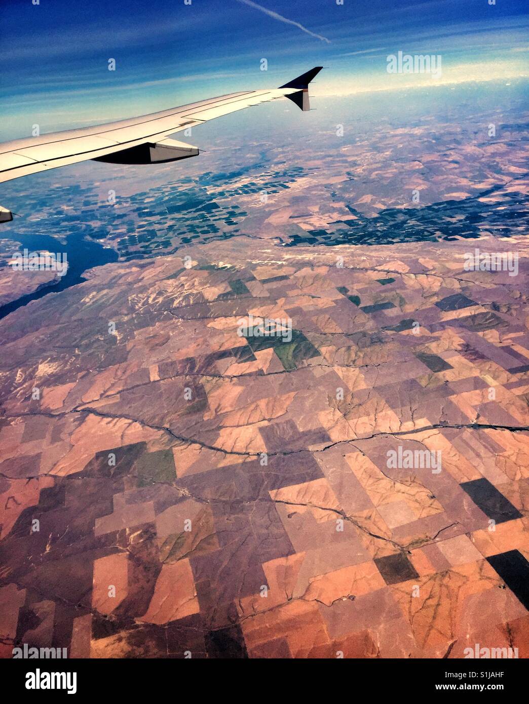Plane wing above patchwork of fields in Pendleton, Oregon, home for famous blankets Stock Photo